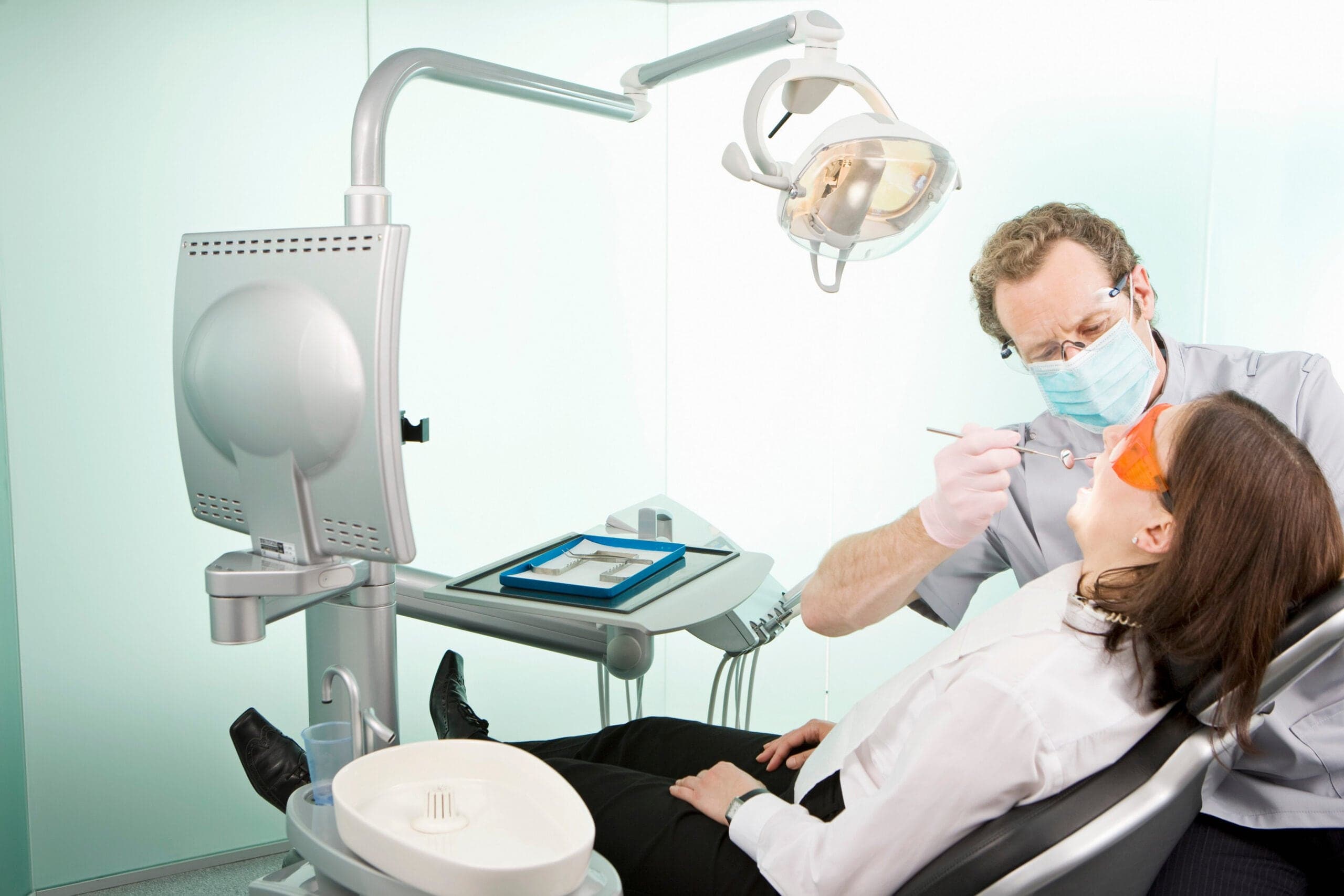 Dentist examining a patient in a treatment room